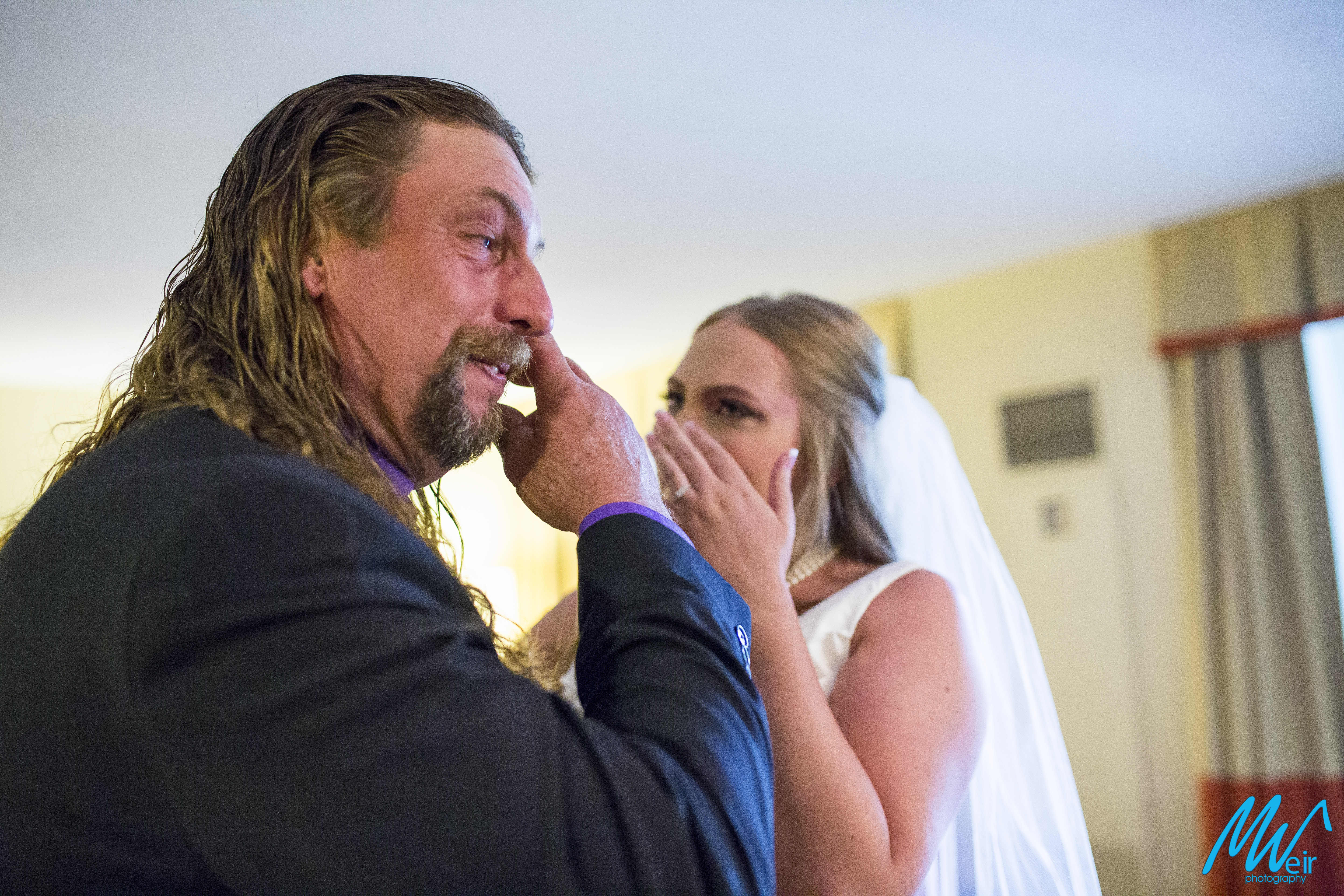 father of the bride crying after seeing his daughter in wedding dress