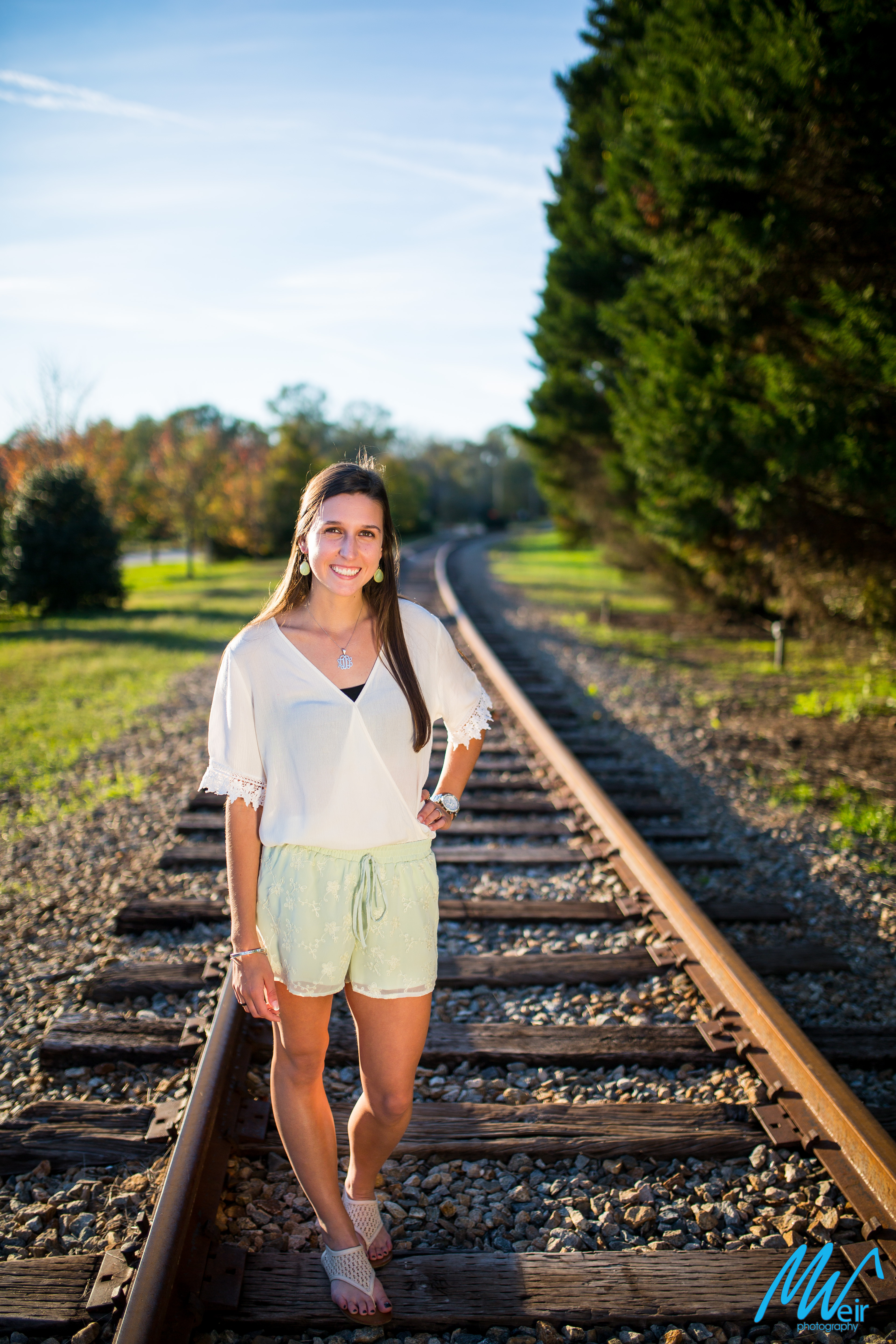 high school senior on rail road tracks