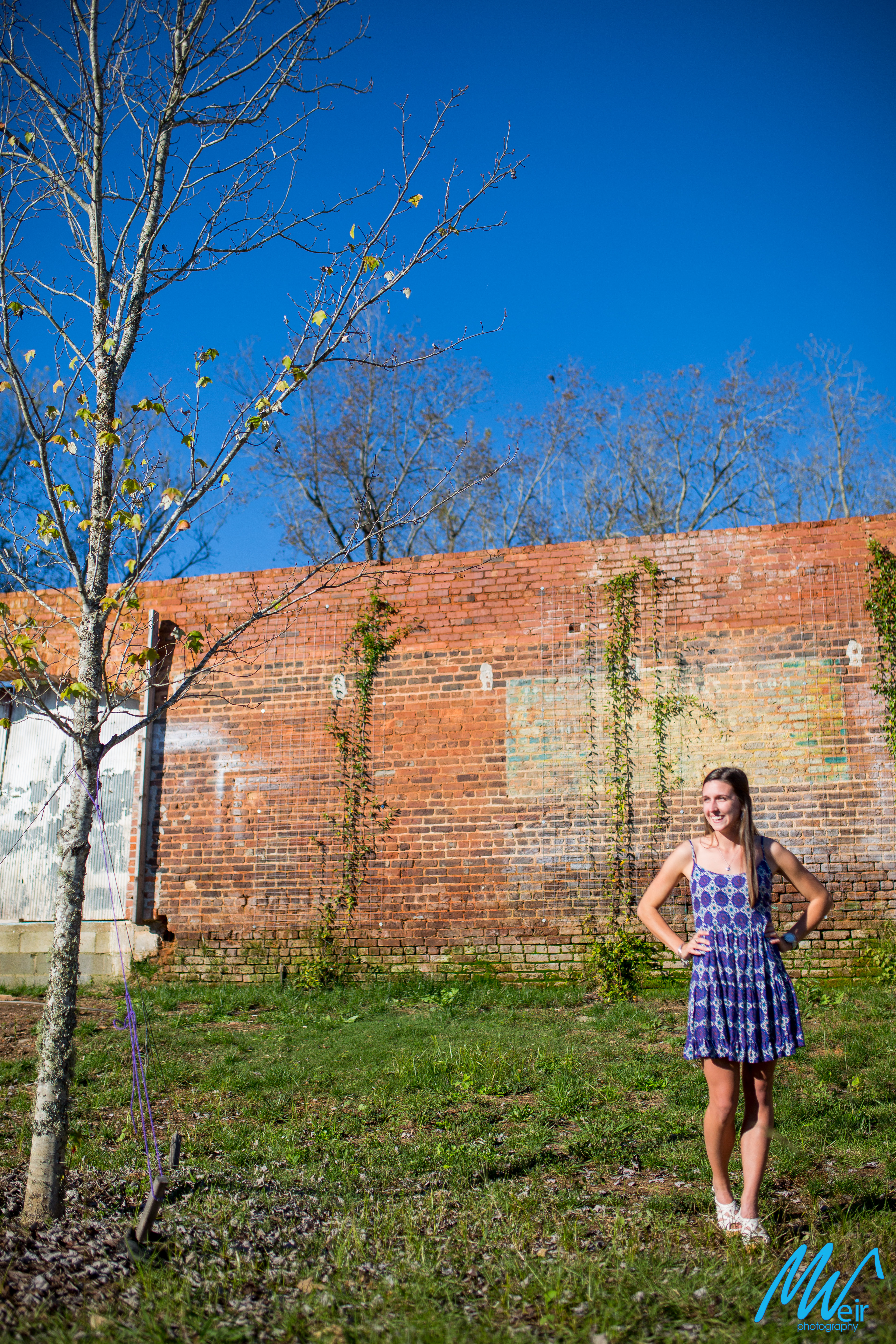 high school senior in front of old rustic building