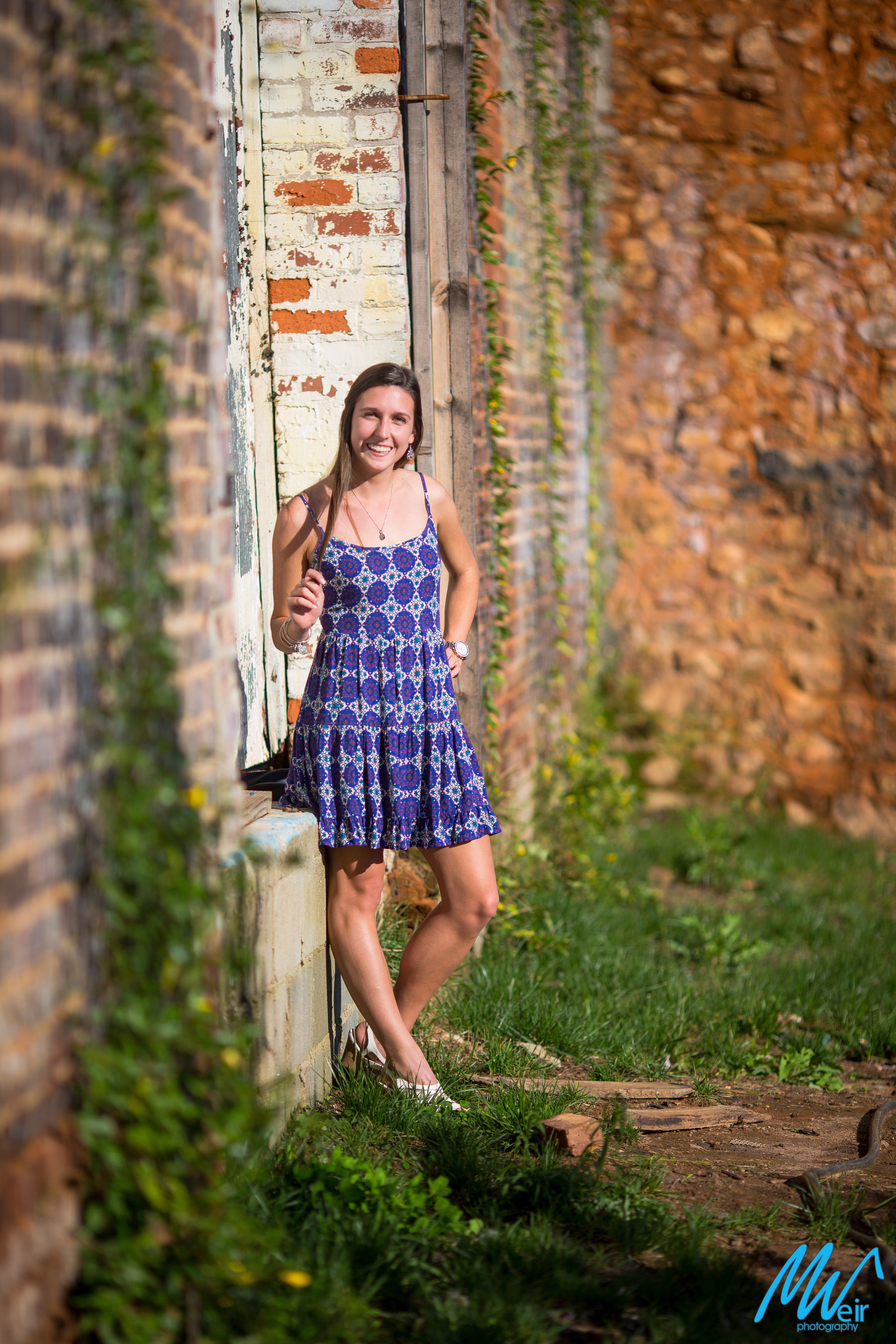 high school senior in front of an old rustic building