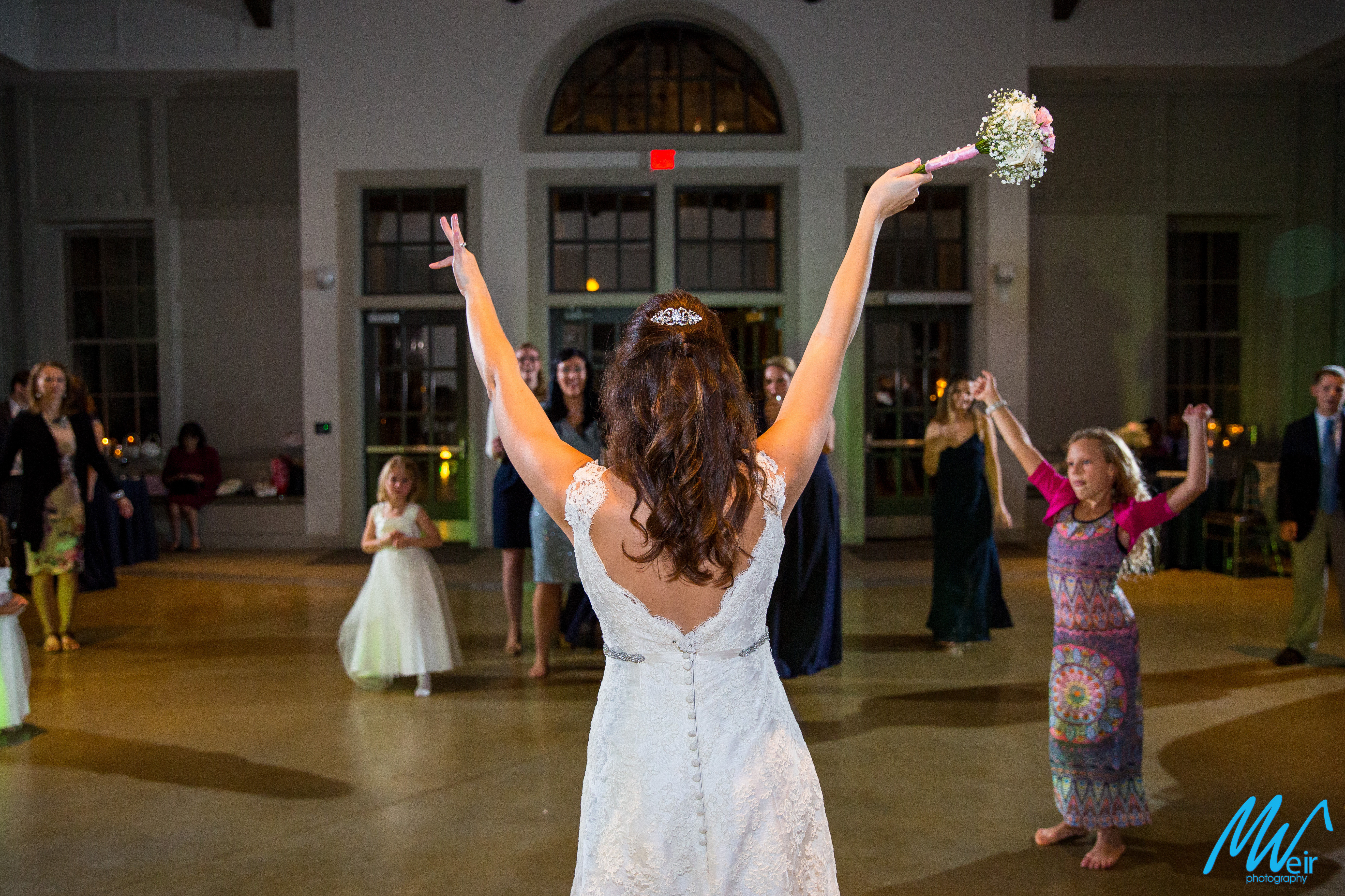 bride tosses bouquet to single ladies