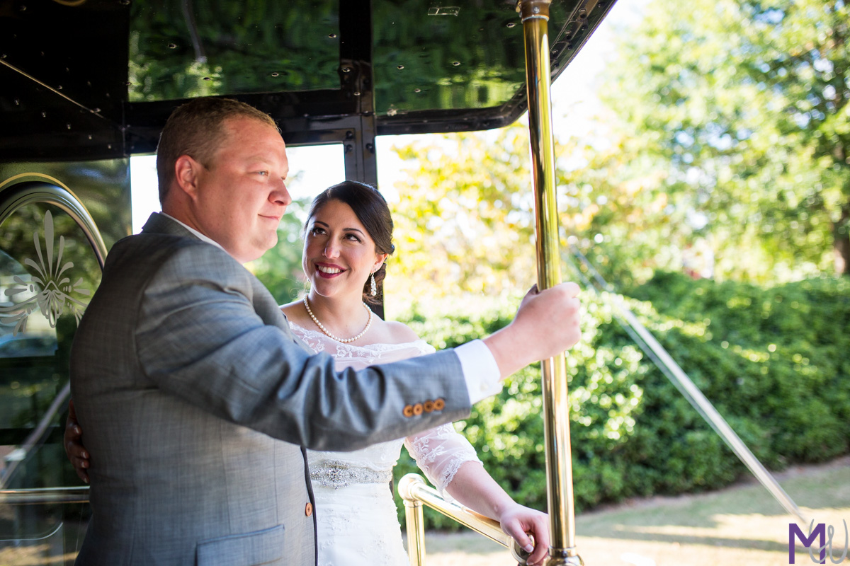 bride and groom on the back of a trolley car