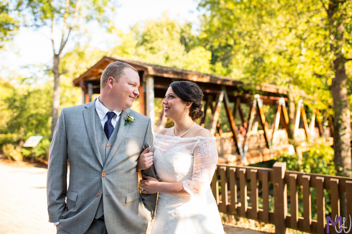 bride and groom in front of roswell mill