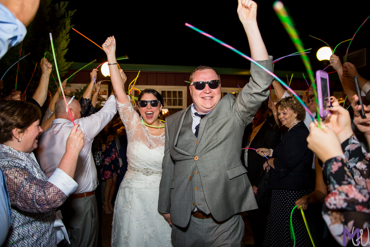 bride and groom grand exit with glow sticks