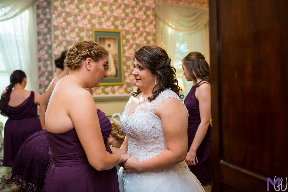 maid of honor gives pep talk to bride before the first look