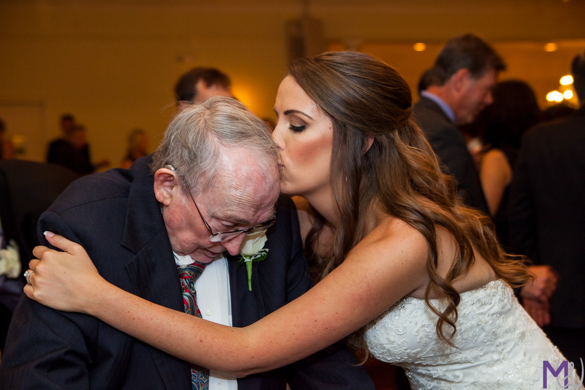 bride gives grandpa a kiss