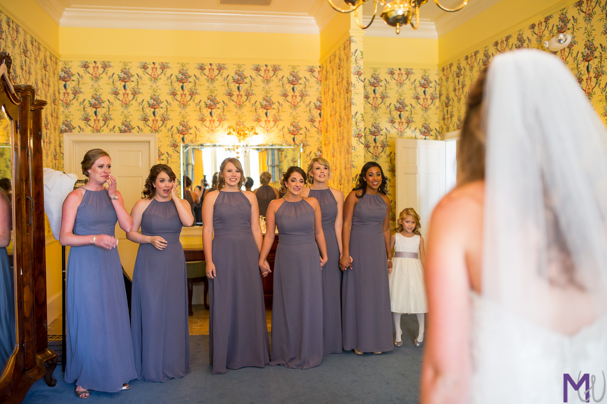 bridesmaids see bride in her dress