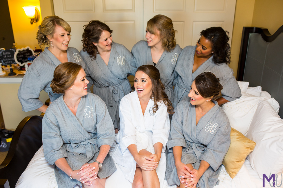 bridesmaids in robes on a bed