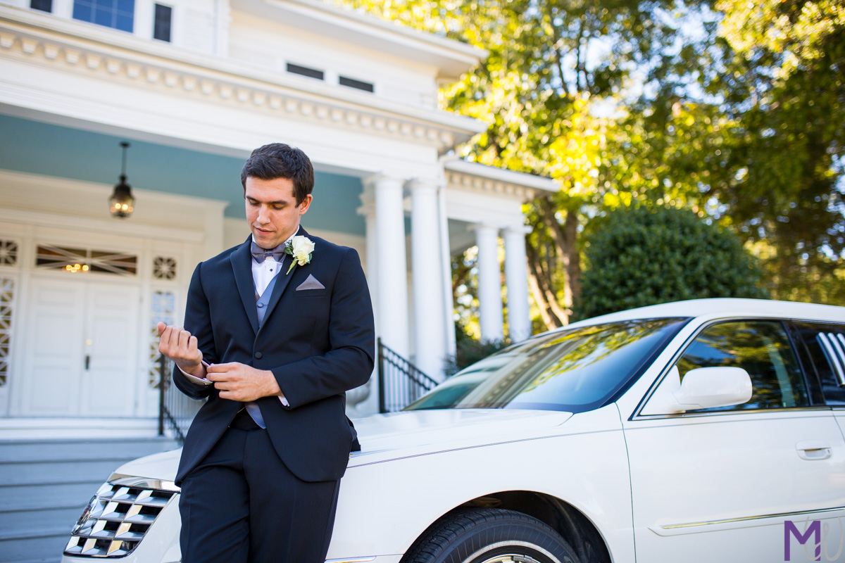 groom against a limo