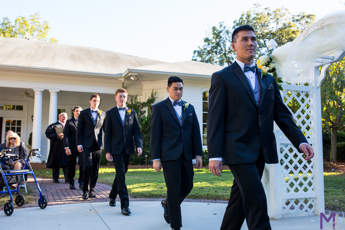groomsmen walk into ceremony
