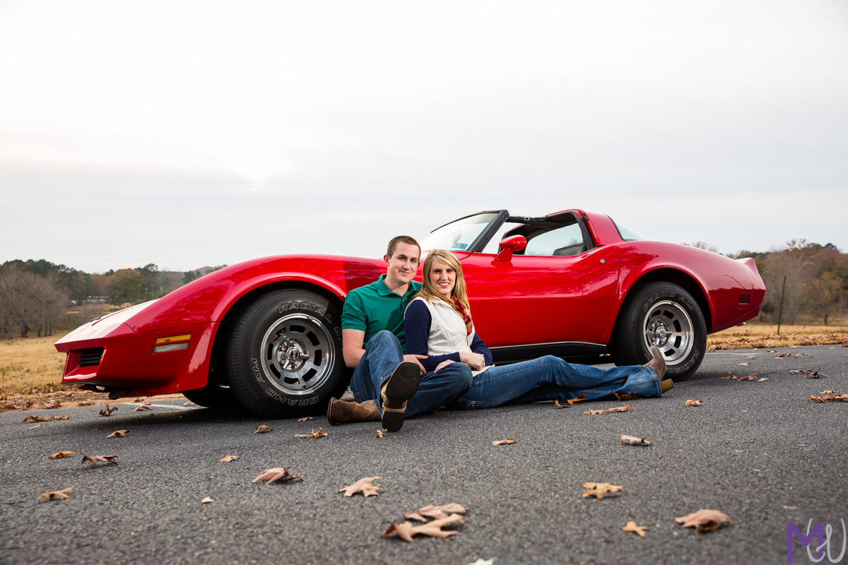engagement photos in front of red corvette