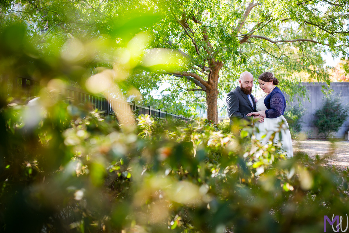 bride and groom look at brides ring