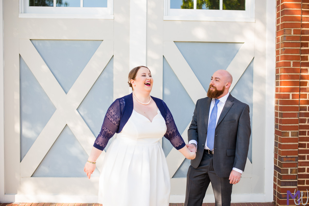 bride and groom in front of barn doors
