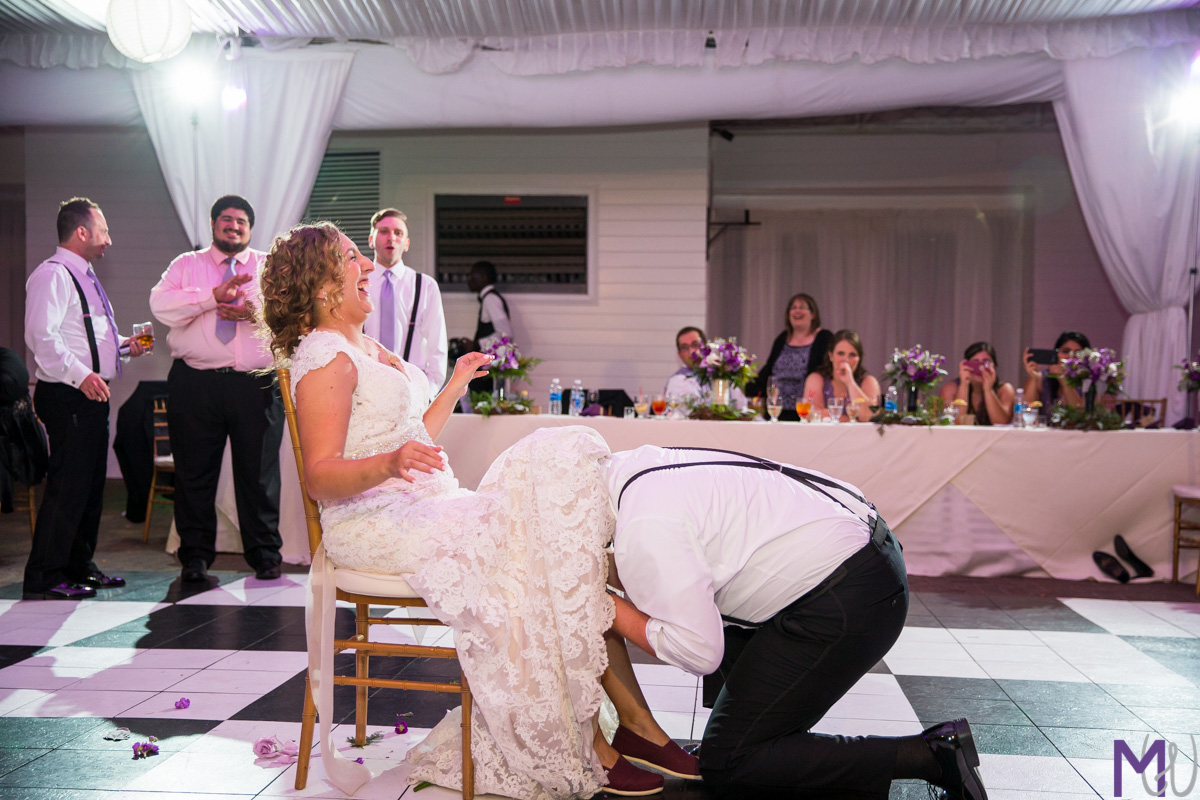 groom takes garter off bride