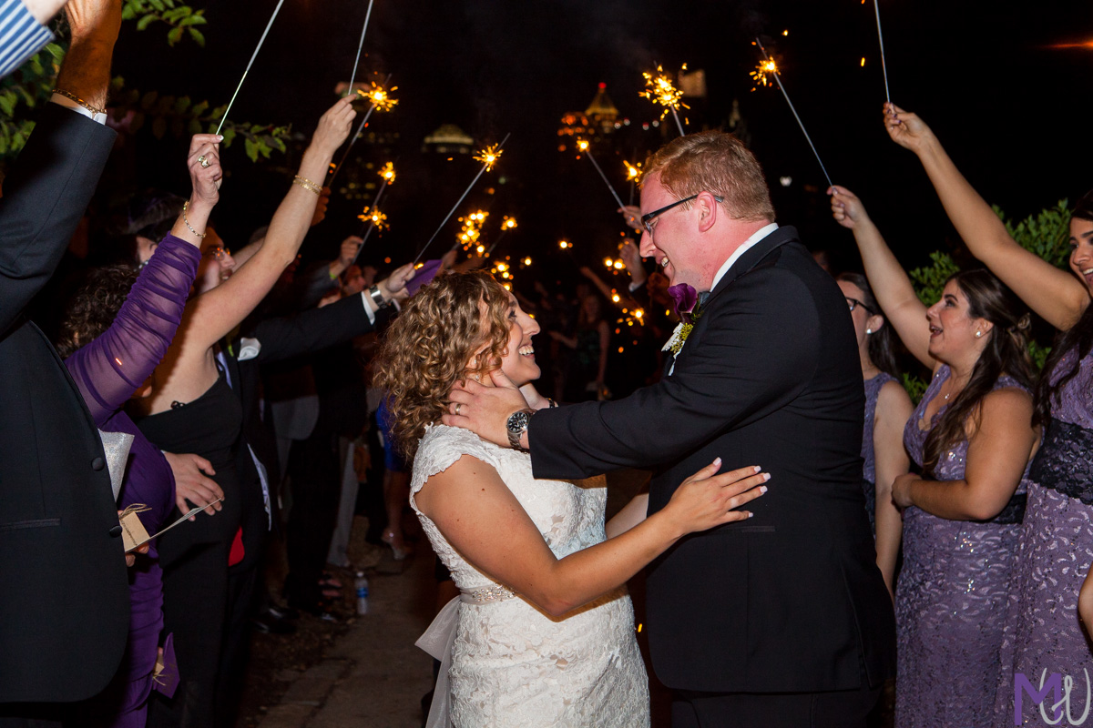 bride and groom leave under sparklers