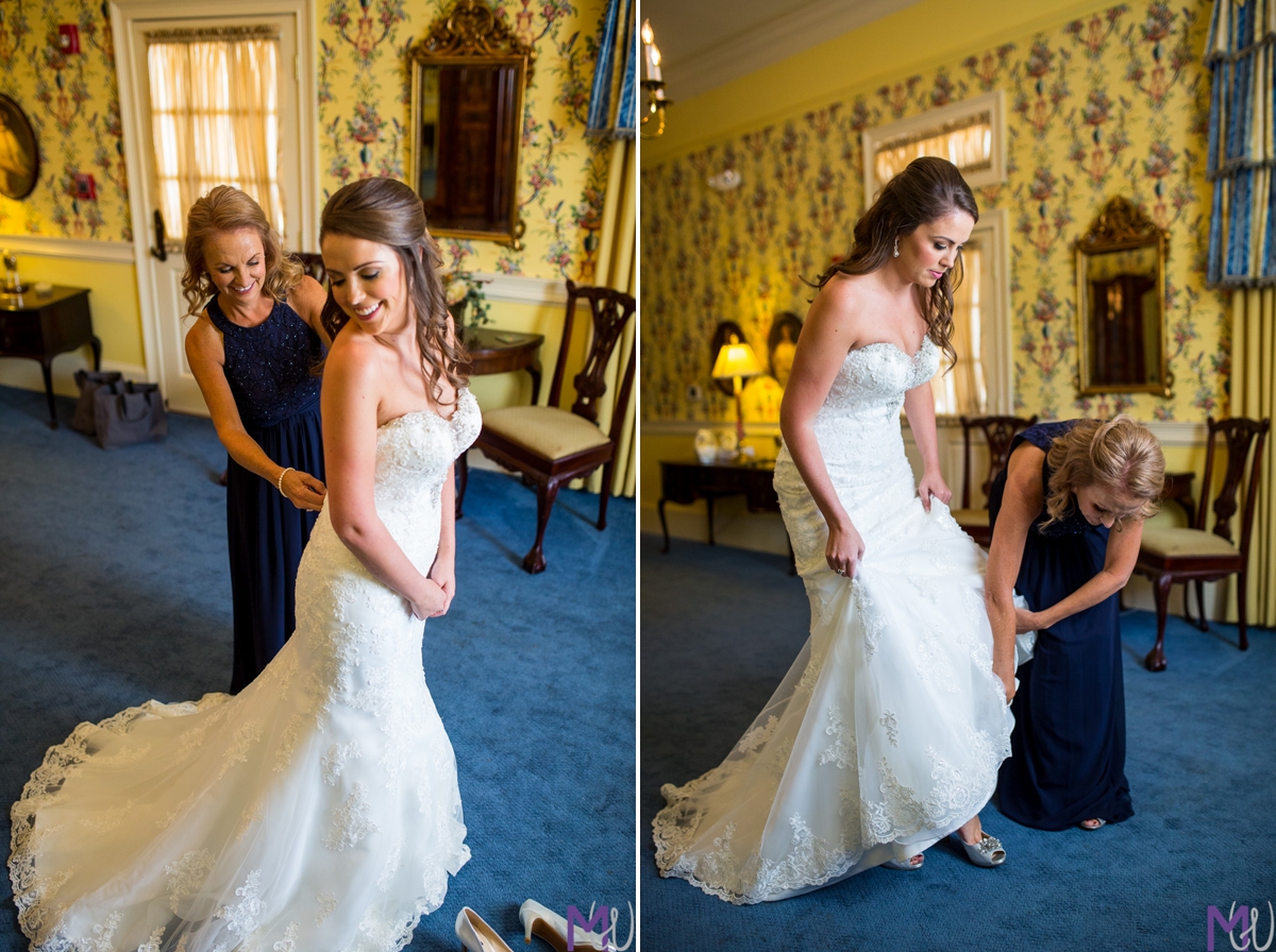 mother of the bride helping bride into dress