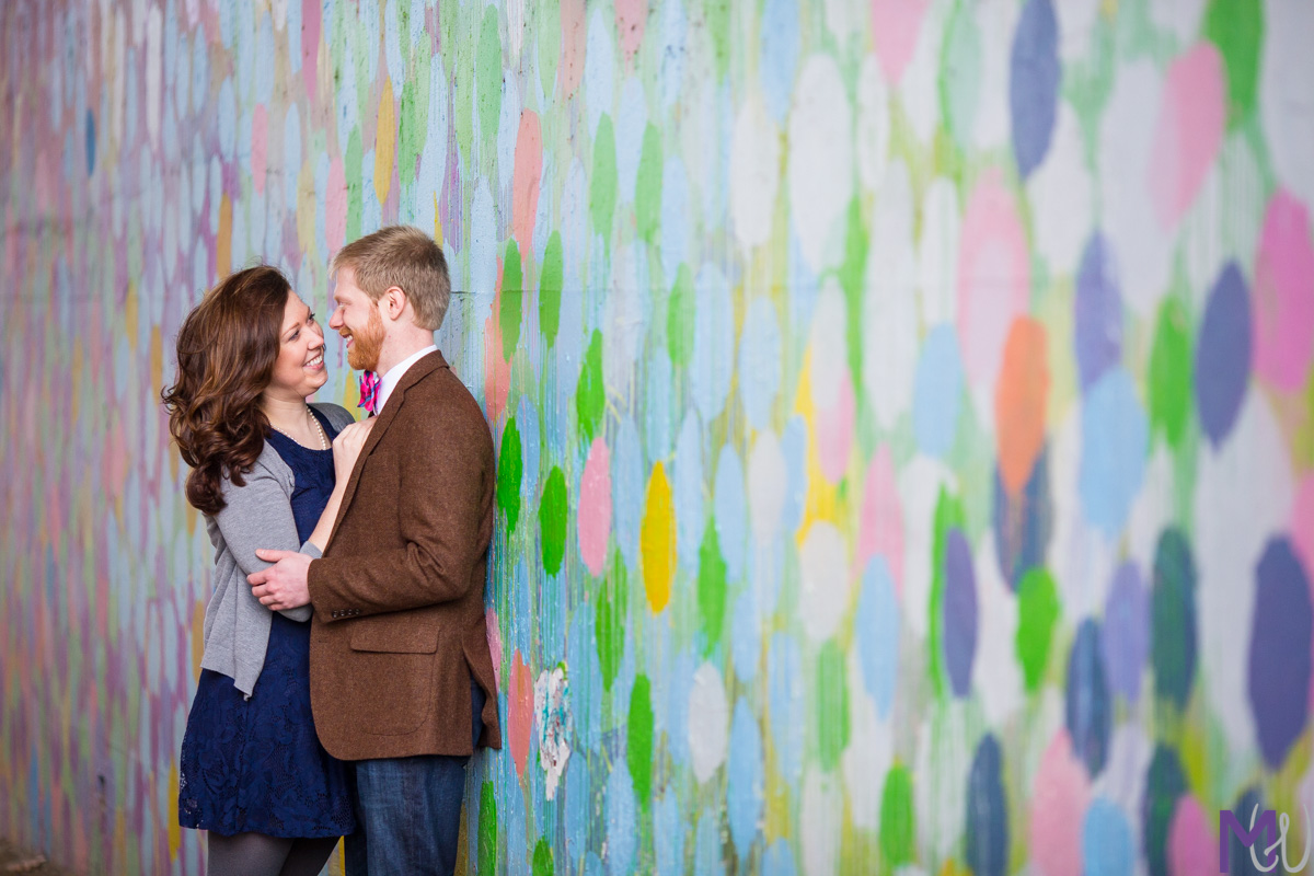 engaged couple in front of polka dot wall on atlanta beltline
