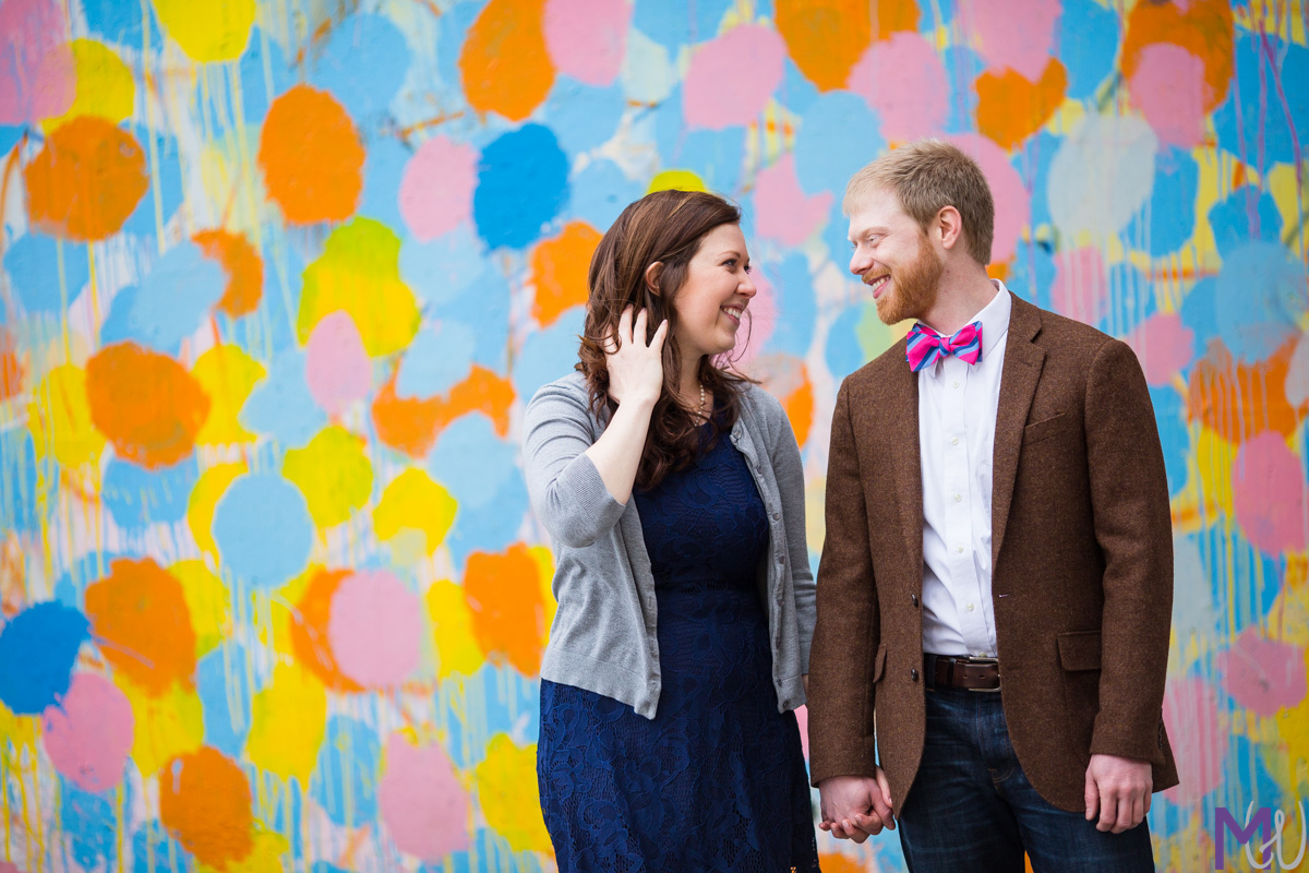 engaged couple in front of polka dot wall on atlanta beltline