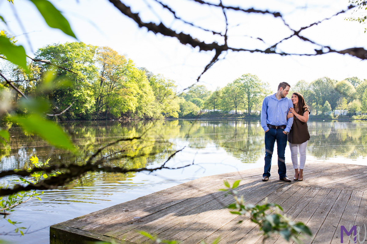 bride and groom in front of a lake