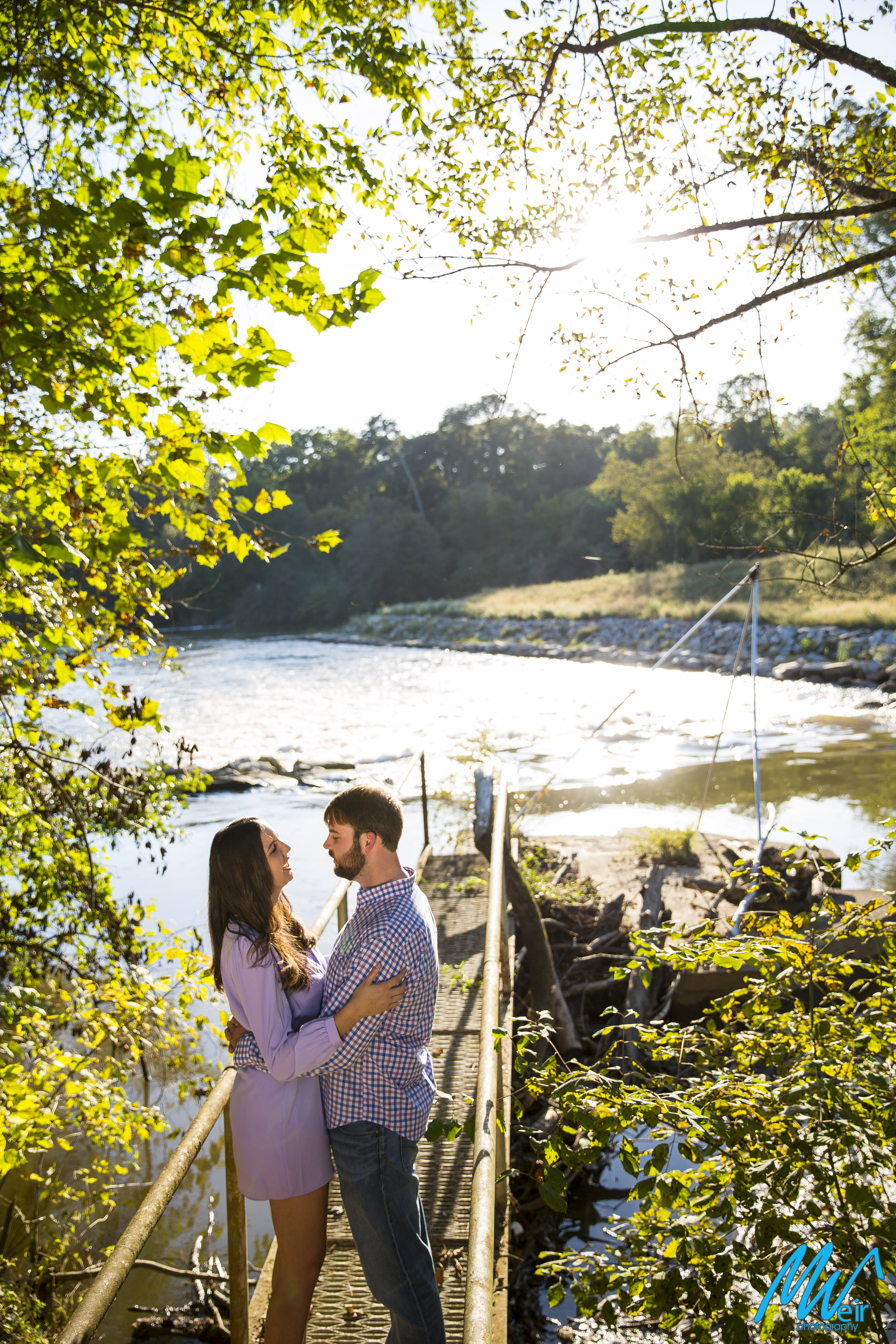 bride and groom stand in a bridge next to Chattahoochee river