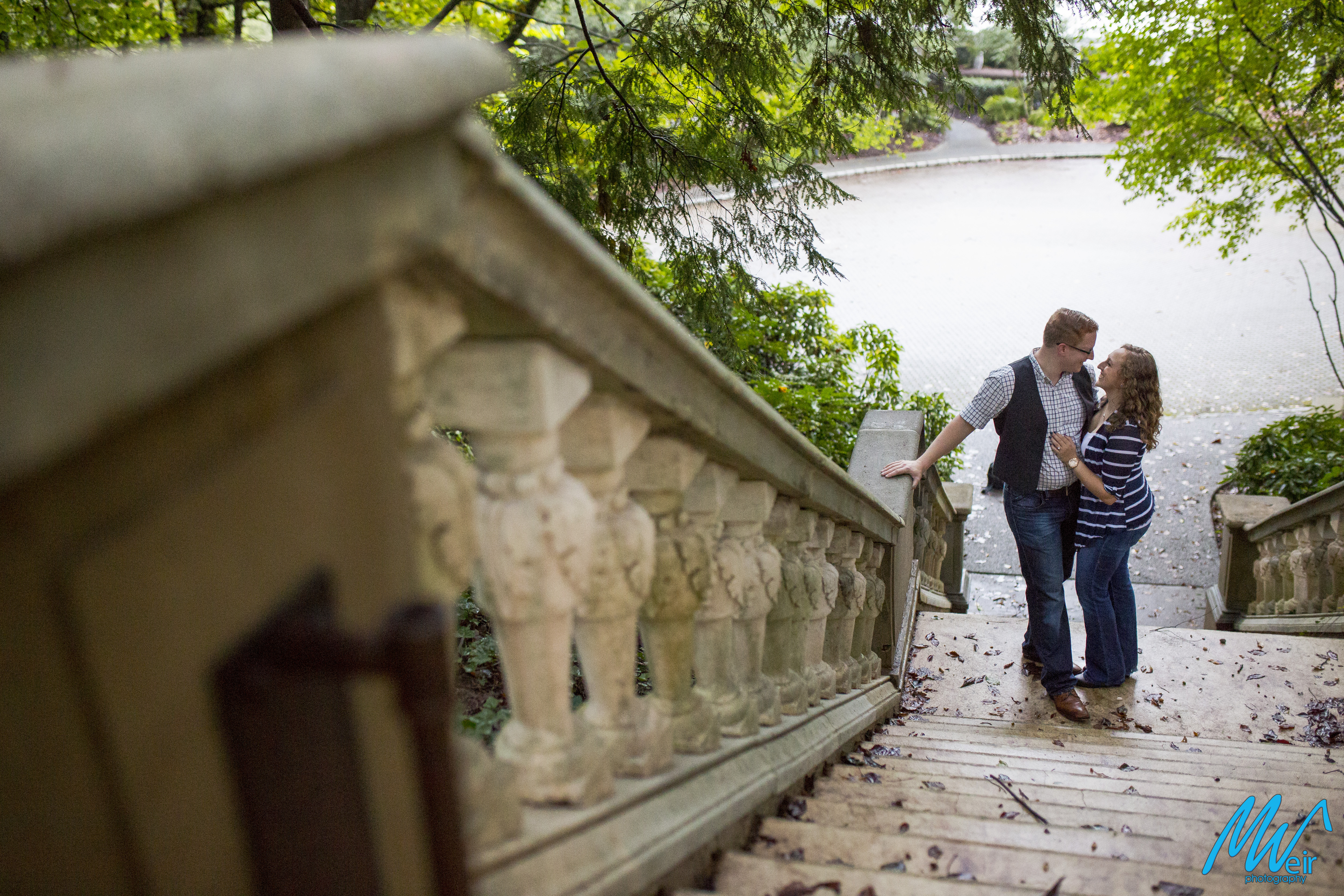 bride and groom gaze into each others eyes on stone steps